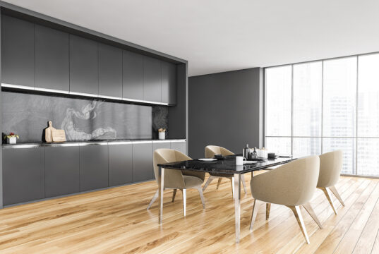 Black And White Minimalist Kitchen, Black Table And Beige Chairs Near Window With City View, Side Vi